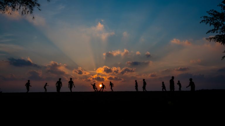 People walking at sunset